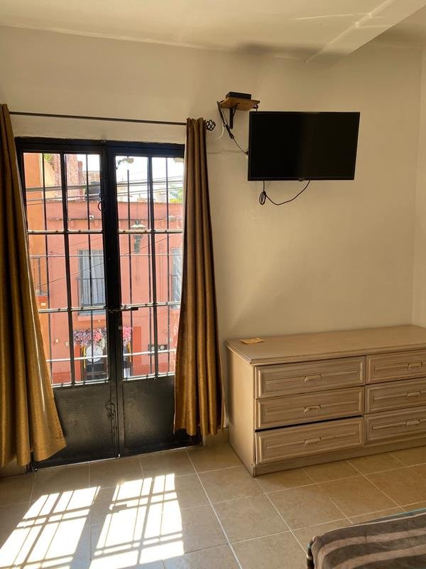 Habitación con TV y puerta al balcón